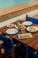 a wooden table with plates of food on it at Hotel Saint Georges Beirut in Al Marfaʼ