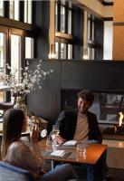 a man and woman sitting at a table in a restaurant at Four Seasons Resort Vail in Vail