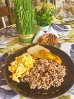 a black plate of food on a table at Casa BOHÖ in Puerto Viejo