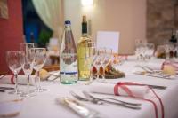 a table with glasses and a bottle of wine at Hotel Vallecetta in Bormio
