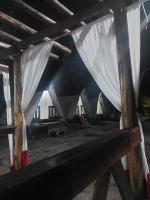 a group of white curtains in a building at Camping rock in Itanhaém