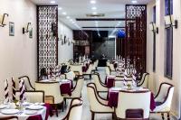 ein Restaurant mit Tischen und Stühlen in einem Raum in der Unterkunft Hotel New Riviera bukavu in Bukavu