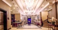 a lobby with a staircase and a chandelier at The Ridge Hotel in Witbank