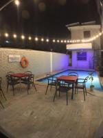 a group of tables and chairs next to a swimming pool at Hotel Restaurant Hamilton in Boca Chica