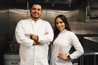 a man and a woman standing in a kitchen at Cambria Hotel El Centro - Imperial in El Centro