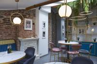 a restaurant with tables and chairs and a fireplace at Modern & Elegant City Center Apartments in Plovdiv