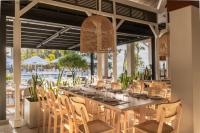 a dining room with a long table and chairs at Cotton Bay Resort & Spa in Rodrigues Island