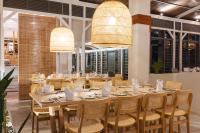 a dining room with a long table and chairs at Cotton Bay Resort & Spa in Rodrigues Island