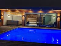a large swimming pool in a room with a bedroom at Domačija Metul in Luče