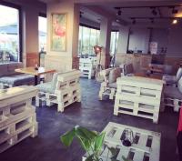 a room with white furniture and tables and windows at Yalı Bahçe Mudanya in Burgaz