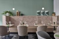 a restaurant with a long table with chairs and wine glasses at June Six Hotel Hannover City in Hannover