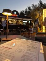 Una mesa con un menú y una luz encima. en Amphitheatro Boutique Hotel, en Meganisi