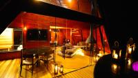 a living room with a table and a couch at Chalé Boutique Spa- Sauna seca, Jacuzzi , Rede suspensa in Campos do Jordão
