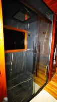a glass door in a room with a window at Chalé Boutique Spa- Sauna seca, Jacuzzi , Rede suspensa in Campos do Jordão