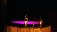 a bathtub with a purple light on top of it at Chalé Boutique Spa- Sauna seca, Jacuzzi , Rede suspensa in Campos do Jordão