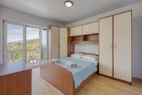 Postel nebo postele na pokoji v ubytování Apartments Grozdana