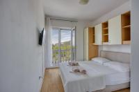 Postel nebo postele na pokoji v ubytování Apartments Grozdana