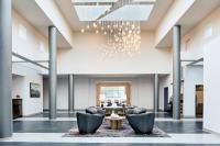 a lobby with chairs and a table and a chandelier at Delta Hotels by Marriott Toledo in Toledo