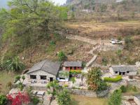 an aerial view of a house on a hill at River Edge Resort Nepal in Benighāt