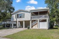 ein großes weißes Haus mit einer Veranda in der Unterkunft Domingos Beach Bungalow- Surfs Up in Myrtle Beach