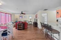 ein Wohnzimmer mit einem roten Sofa und Stühlen in der Unterkunft Domingos Beach Bungalow- Surfs Up in Myrtle Beach