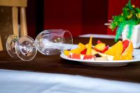 a plate of fruit on a table with glasses at Hotel Orphey in Bansko
