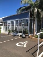 a building with a parking lot with a parking sign at Lindsey Hôtel in Saint-Pierre