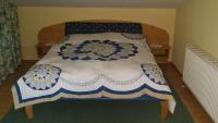 a bedroom with a bed with a blue and white comforter at Haus Schartner in Daar