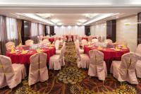 a banquet room with tables and white chairs with red table cloth at Shenzhen Jincheng Hotel in Shenzhen