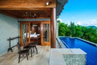 a house with a swimming pool and a bedroom at Panviman Resort Koh Phangan - SHA Extra Plus in Thong Nai Pan Noi