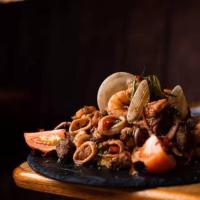 a pile of food on a plate on a table at Villa Vacacionales Los Cayos Con Playa Privada in Boca de Aroa