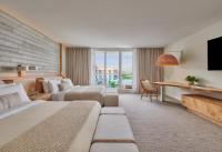 ein Hotelzimmer mit zwei Betten und einem Fernseher in der Unterkunft 1 Hotel South Beach in Miami Beach