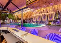 een zwembad met paarse stoelen en kroonluchters bij Mermaid Beach Resort in Jomtien Beach