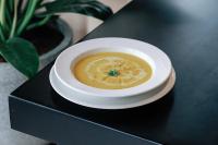 a bowl of soup on a black table at Lamori Resort & Spa in Thanh Hóa