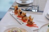 a plate of food on a table with a plate of food at Lamori Resort & Spa in Thanh Hóa