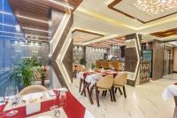 a dining room with tables and chairs in a restaurant at Airport Diana Hotel in Kathmandu