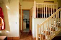 a staircase in a house with a stair case at Hotel Tugasa Castillo de Castellar in Castellar de la Frontera