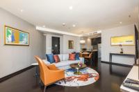 a living room with a couch and a table at Chatrium Hotel Riverside Bangkok in Bangkok