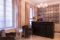 a man sitting at a bar in a room with chairs at Magda Champs Elysées in Paris