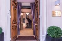 a hallway with a wooden door and purple curtains at Magda Champs Elysées in Paris