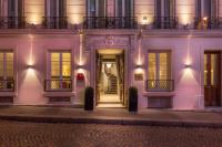 a white building with lights on the facade at Magda Champs Elysées in Paris