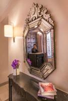 a man taking a picture in a mirror on a table at Magda Champs Elysées in Paris