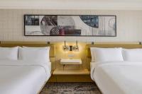 two beds sitting next to each other in a room at Hotel Preston Nashville Airport in Nashville