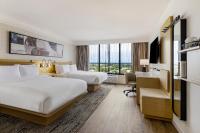 a hotel room with two beds and a desk at Hotel Preston Nashville Airport in Nashville