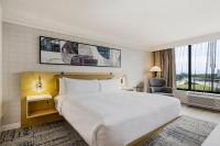 a hotel room with a large bed and a window at Hotel Preston Nashville Airport in Nashville