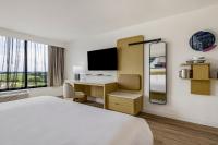 a hotel room with a bed and a desk at Hotel Preston Nashville Airport in Nashville