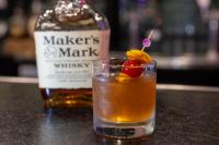 a drink next to a bottle of whiskey at Hotel Preston Nashville Airport in Nashville