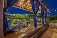 a deck with blue drapes and a table and chairs at Hotel Preston Nashville Airport in Nashville