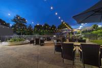 a patio with chairs and tables and an umbrella at Hotel Preston Nashville Airport in Nashville