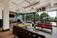 a lobby with couches and tables and windows at Hotel Preston Nashville Airport in Nashville